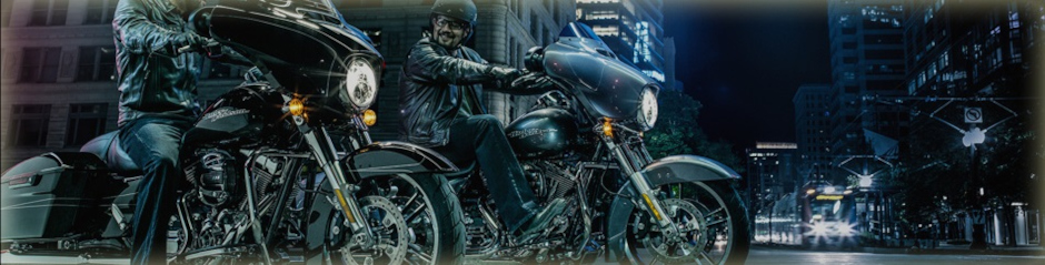 2017 Two Harley-Davidson® motorcycle riders on the street at night.